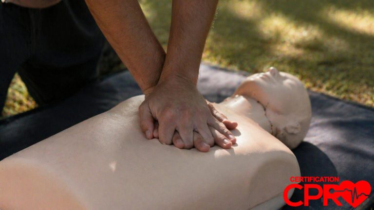 Person performing hands-only CPR on a mannequin outdoors in Fort Worth.